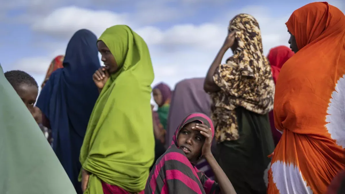 Somali women wait their turn to collect water at a camp for displaced people on the outskirts of Dollow, Somalia on Monday, Sept. 19, 2022.